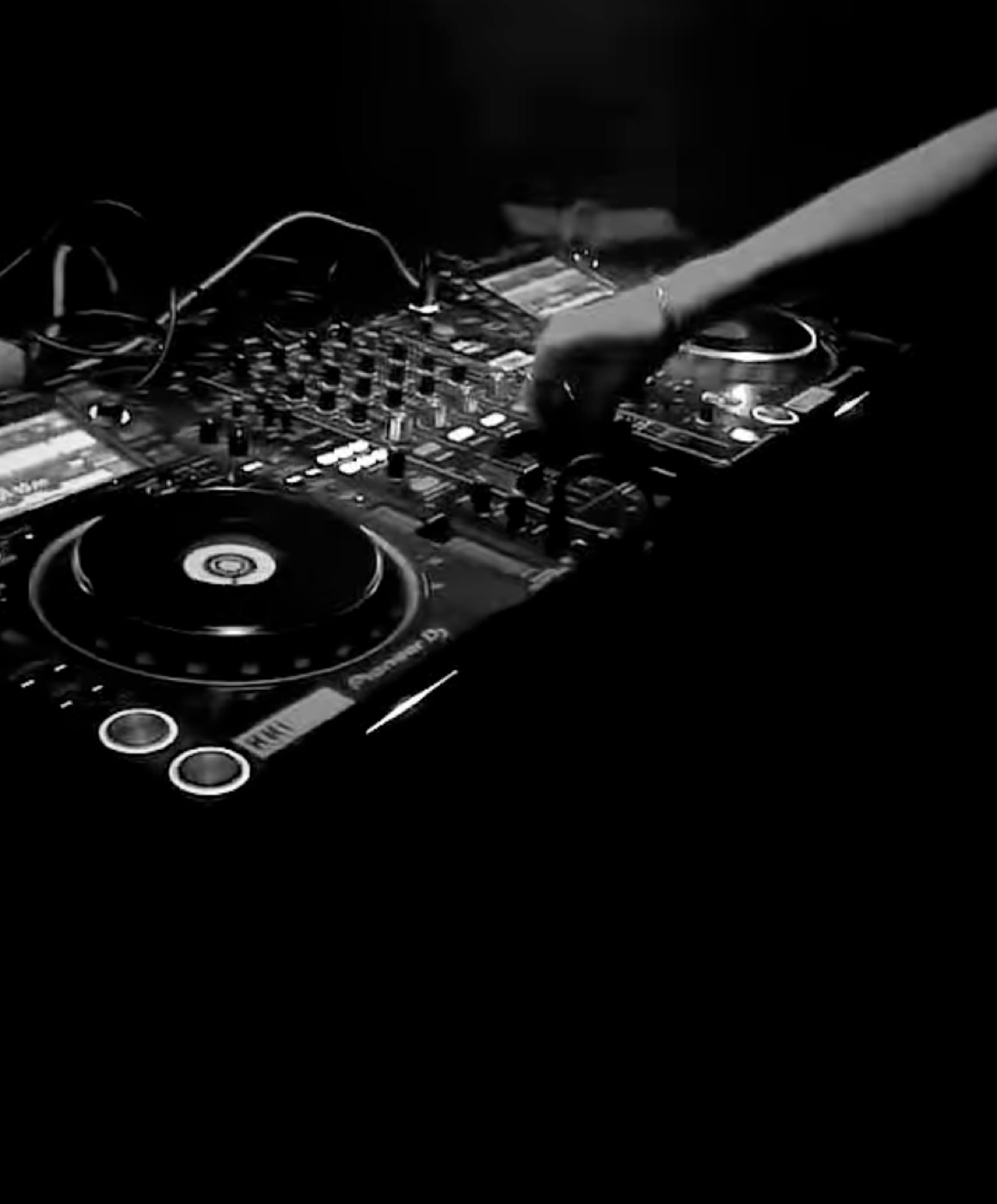 Hands on a CDJ in black and white